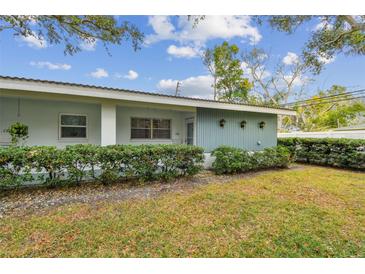 Ranch style home with light blue exterior, well-manicured lawn, and hedges at 11200 102Nd Ave # 138, Seminole, FL 33778