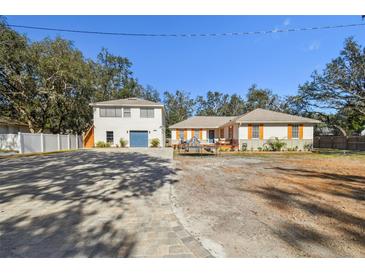 Newly renovated home with a large driveway and detached garage at 13833 Vacation Ln, Odessa, FL 33556