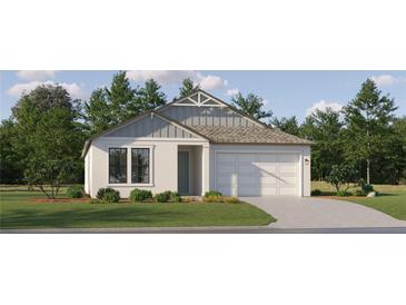 One-story home with gray siding, white trim, and a two-car garage at 18426 Serene Lake Loop, Lutz, FL 33548