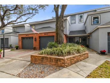 Inviting exterior of a two-story townhome with a brick facade and landscaped front yard at 2519 Crowder Ln, Tampa, FL 33629