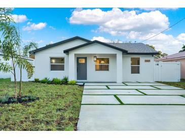 Newly constructed home with modern facade, driveway, and landscaping at 2905 W Collins St, Tampa, FL 33607