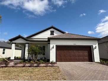 Beautiful home featuring a brick driveway, two car garage, and manicured lawn at 31819 Cardinal Yard Dr, San Antonio, FL 33576