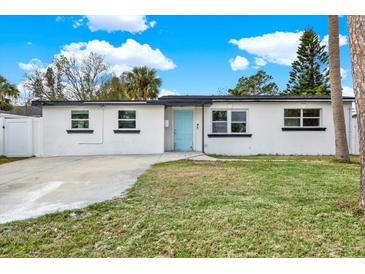 Updated home with fresh paint, new windows, and a well-manicured lawn at 4234 Des Moines Ne St, St Petersburg, FL 33703