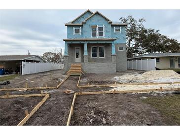 Two-story craftsman style home under construction with a front porch and landscaping at 441 42Nd Ne Ave, St Petersburg, FL 33703