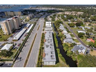 Aerial view of a waterfront community with multiple buildings and lush landscaping at 4455 Duhme Rd # 305, St Petersburg, FL 33708