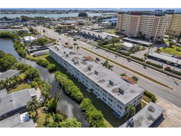 Aerial view of condo building near water, showing surrounding landscape and nearby buildings at 4455 Duhme Rd # 305, St Petersburg, FL 33708