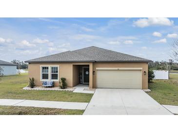 One-story home with a two-car garage and landscaped lawn at 701 Garden Oaks Sq, Seffner, FL 33584