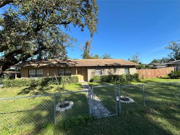 Ranch-style home with a fenced yard and mature trees at 804 E 128Th Ave, Tampa, FL 33612