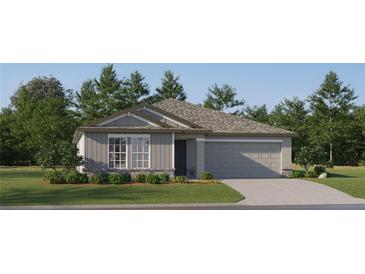 Single-story home with gray siding, stone accents, and a two-car garage at 8418 Bella Mar Trl, Parrish, FL 34219