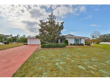 Ranch style home with red brick driveway and mature landscaping at 1807 Pineapple Palm Ct, Sun City Center, FL 33573