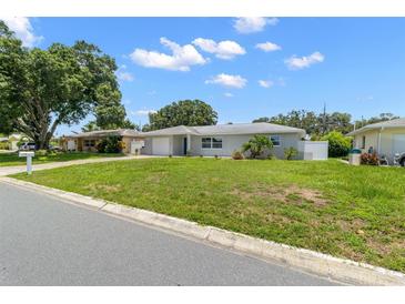 Newly renovated home with a well-maintained lawn at 10971 90Th Ave, Seminole, FL 33772
