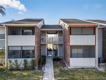 Condo building exterior with walkway and screened balcony at 1400 Gandy N Blvd # 506, St Petersburg, FL 33702