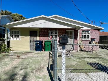 Brick duplex with fenced yard and off-street parking at 2105 W Gray St, Tampa, FL 33606