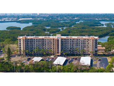 Aerial view of a waterfront condo building with parking and lush landscaping at 5400 Park N St # 209, St Petersburg, FL 33709