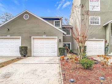 Townhouse exterior with two-car garage and landscaping at 5832 Red Cedar Ln, Tampa, FL 33625