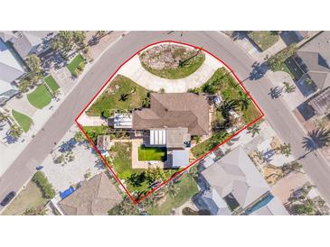 Aerial view of a single-Gathering home with a pool and large backyard at 911 Boca Ciega Isle Dr, St Pete Beach, FL 33706