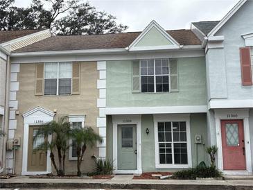 Three-unit townhouse complex with two-story buildings and landscaped grounds at 11356 Stratton Park Dr, Temple Terrace, FL 33617