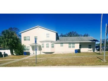 Tan two-story house with multiple windows and a landscaped yard at 1434 Cleveland St # 4, Clearwater, FL 33755