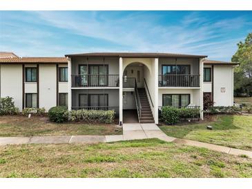 Two-story condo building with balconies and landscaped grounds at 1882 Pine Ridge W Way # E1, Palm Harbor, FL 34684