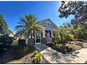 Charming house exterior featuring a screened porch and walkway at 204 Latitude Pl, Apollo Beach, FL 33572