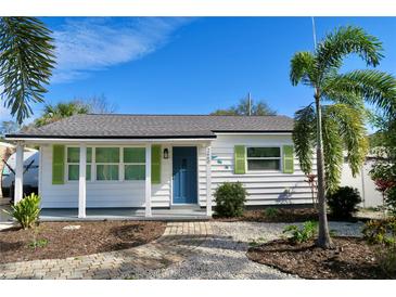 Charming bungalow with white siding, green shutters, and a landscaped front yard at 2660 Miriam S St, Gulfport, FL 33711