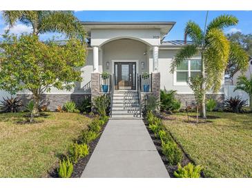 Curb appeal abounds at this beautiful home, featuring a landscaped yard and inviting entryway at 3925 1St Ne St, St Petersburg, FL 33703