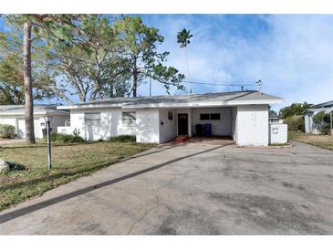 White single story home with carport and small front yard at 4730 Shore Acres Ne Blvd, St Petersburg, FL 33703