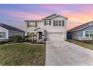 Two-story house with gray shutters, stone accents, and a two-car garage at 5130 Adega Way, Bradenton, FL 34211