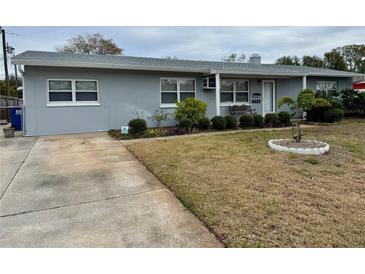 Gray house with a well-maintained lawn and driveway at 6623 16Th N St, St Petersburg, FL 33704