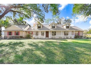 Spacious ranch house with a large front yard and mature trees at 6819 Stafford Rd, Plant City, FL 33565