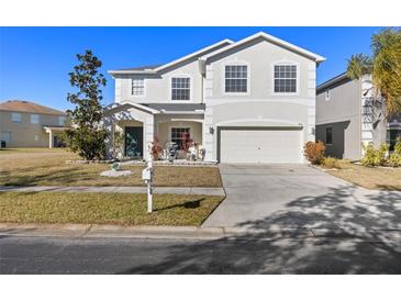 Two-story house with a large driveway and landscaping at 8919 N River Rd, Tampa, FL 33635