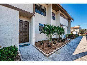 Attractive condo building exterior with landscaping and a well-maintained entrance at 9209 Seminole Blvd # 138, Seminole, FL 33772