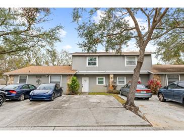 Two-story townhome with parking and landscaping at 10061 Lake Oak Cir, Tampa, FL 33624