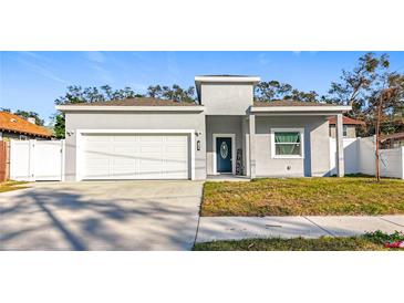 Gray house with white garage door and landscaping at 1103 S Prospect Ave, Clearwater, FL 33756