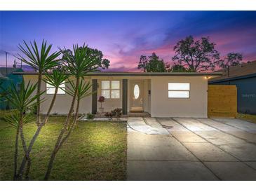 Updated bungalow with modern facade, fresh landscaping, and a long driveway at 3726 Abington S Ave, St Petersburg, FL 33711