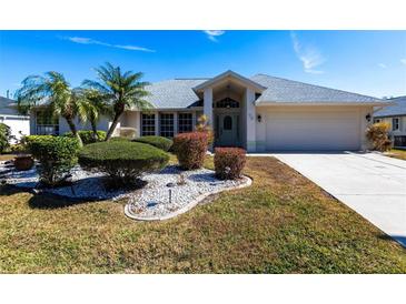 Single-story home with landscaped yard and attached garage at 72 Norman St, Port Charlotte, FL 33954