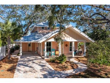 Charming two-story home with a metal roof and landscaped yard at 728 Wood St, Dunedin, FL 34698