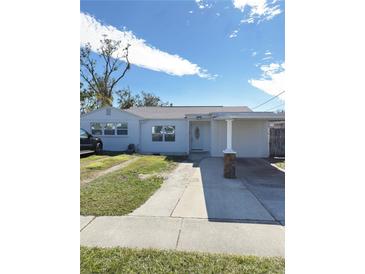 White single story house with carport and landscaped lawn at 2910 W Burke St, Tampa, FL 33614