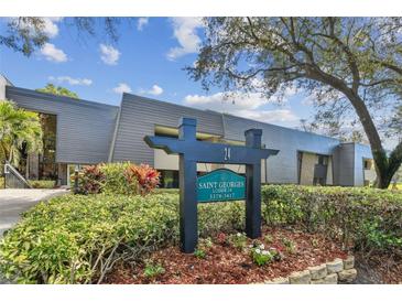 Attractive building exterior with sign and landscaping on a sunny day at 36750 Us Highway 19 # 24209, Palm Harbor, FL 34684