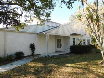 White single story home with mature landscaping and a spacious yard at 4708 Lacrosse Ct, New Port Richey, FL 34655