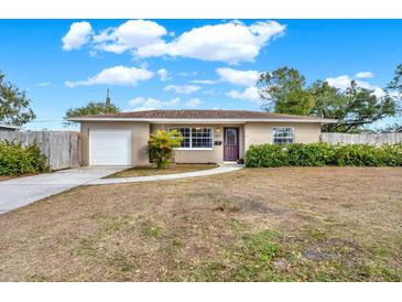 Ranch style home with carport, mature landscaping, and a spacious yard at 7095 17Th N Way, St Petersburg, FL 33702