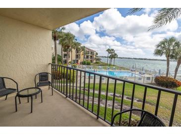 Balcony view of waterfront pool and bay at 7520 Sunshine Skyway S Ln # T18, St Petersburg, FL 33711