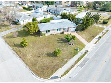 Aerial view of a single-story house with a large front yard and driveway at 1004 Orlando Ave, Bradenton, FL 34207
