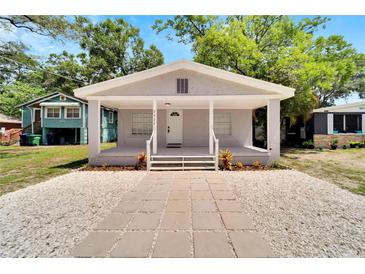 Charming bungalow with a covered porch and well-manicured front yard at 2622 E Genesee St, Tampa, FL 33610