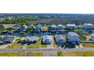 Aerial view of canal-front property with a large lot and nearby waterfront homes at 4024 Centavo Ct, Hernando Beach, FL 34607