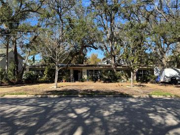 Ranch-style home with mature landscaping and a spacious yard at 4829 W San Jose St, Tampa, FL 33629