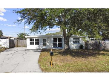 Newly renovated home with a carport and well-manicured lawn at 8719 92Nd Ter, Seminole, FL 33777