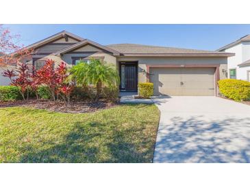 One-story home with a two-car garage and landscaped yard at 12312 Bay Estuary Bnd, Riverview, FL 33579