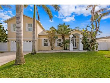 Two-story house with attached garage, lush lawn, and palm trees at 538 25Th Se Ave, St Petersburg, FL 33705