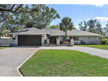 Updated single-story home with a large driveway and landscaped lawn at 900 31St Ne Ave, St Petersburg, FL 33704